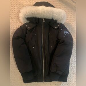 Kids Moose Knuckles Unisex Bomber winter jacket in black with white fur trim